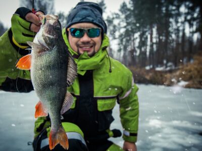 Ice Fishing Success with Man Holding a Fish