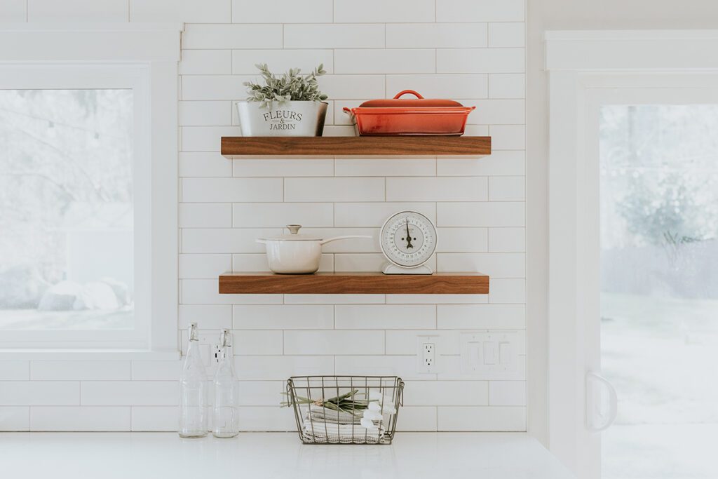 Wall shelves with kitchen essentials as decor doubles as storage space.
